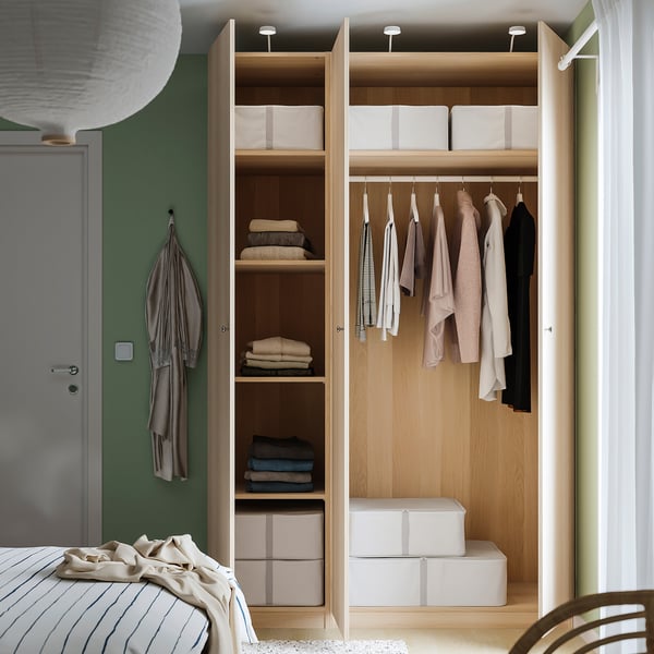 Open PAX closet with clothes and lighting.