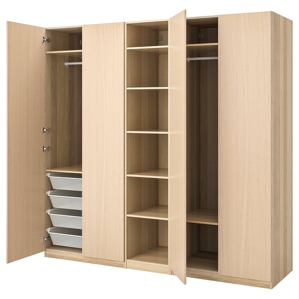 An open ikea PAX wardrobe in light oak. It displays shelves, drawers, and hanging space for clothes.