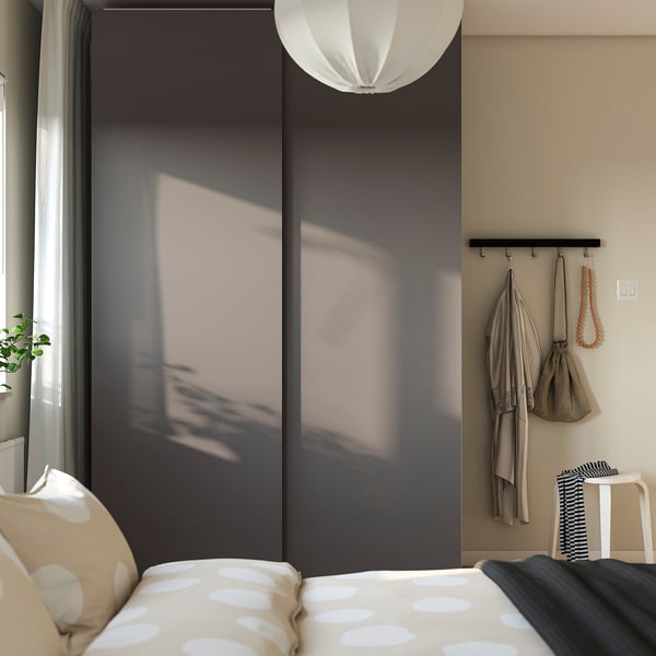 Modern bedroom with PAX wardrobe, polka-dot bedspread, and decorative accessories.