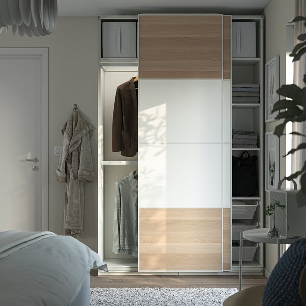 Modern wardrobe with sliding mirrored doors and interior hanging and shelving storage.