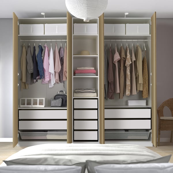 Modern open wardrobe with clothes, shelves, drawers, and baskets.