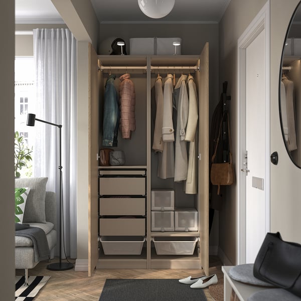 Modern closet with hanging coats, drawers, and storage bins; integrated lighting, soft-close hinges.