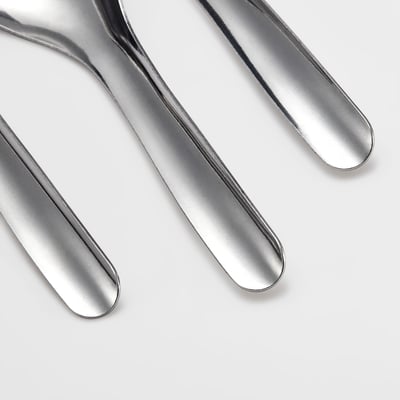 Three polished metallic spoons arranged neatly, reflecting light, showcasing high-quality, smooth, and shiny surfaces.