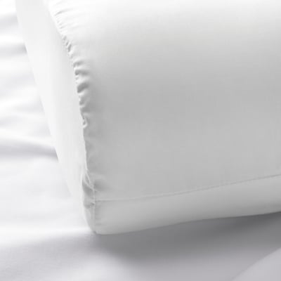 Soft, white bedding with fine stitching, showcasing high-quality cotton and lyocell fabric.