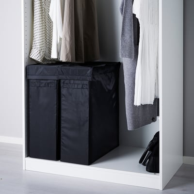 Black SKUBB laundry bags in wardrobe storing clothes and keeping floor clean.