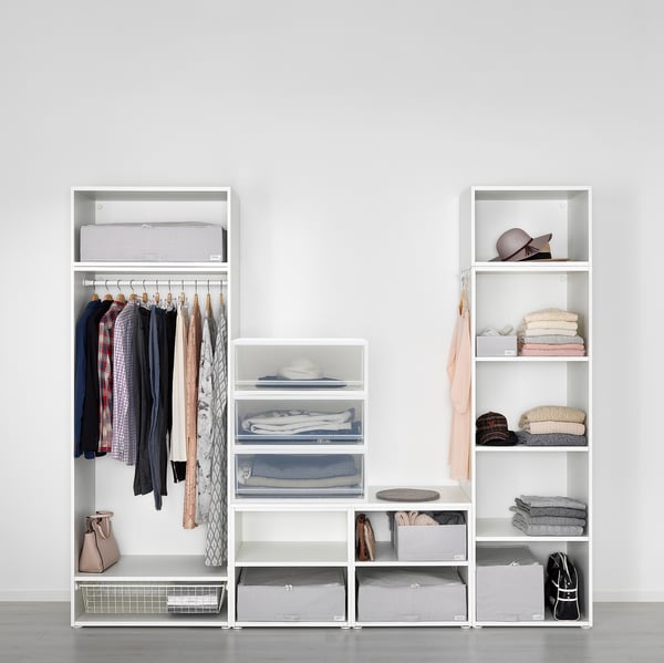 A well-organized closet with hangers, shelves, and drawers, using pull-out storage units.