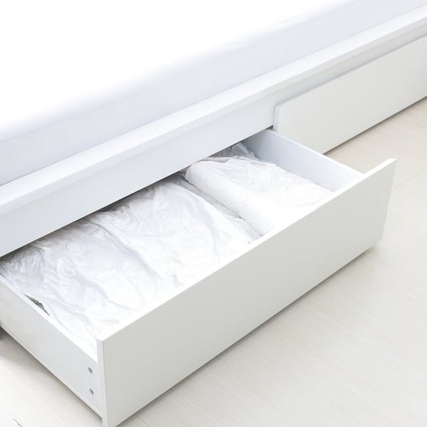 White SPANTAD vacuum bag drawer organiser, compact and minimalist design.