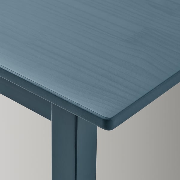 Dark blue childrens table with smooth, rounded edges and visible wood grain texture.