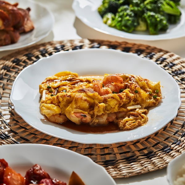 Plate of fried food, sauce, and veggies on white dishware, suitable for various dishes.