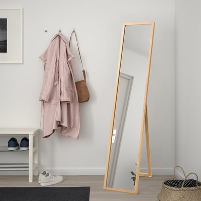 VÄRSNÄS: tall bamboo-framed floor mirror reflects full body, minimalist decor