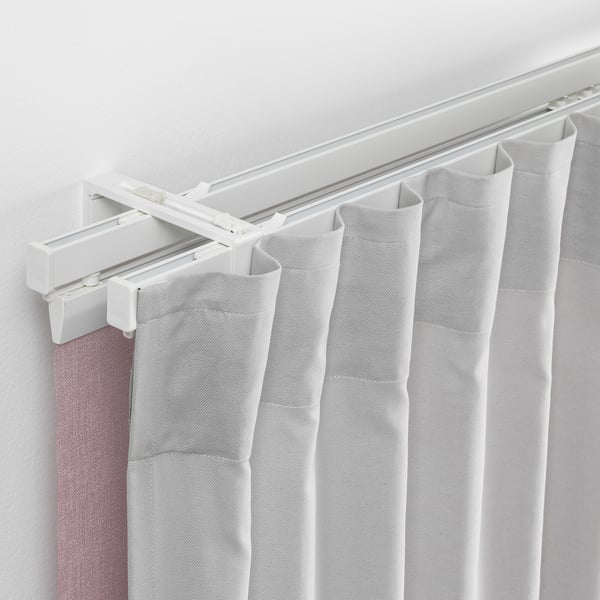 Double rod system with white curtains for privacy and light control.