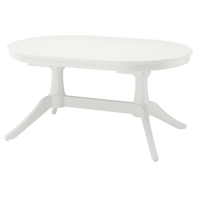 Bela raztegljiva ovalna jedilna miza s trdnimi nogami, ki združuje funkcionalnost in eleganco.
