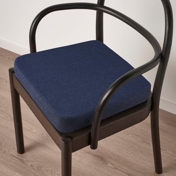 Dark chair with blue cushion; memory foam for comfort, non-slip backing.