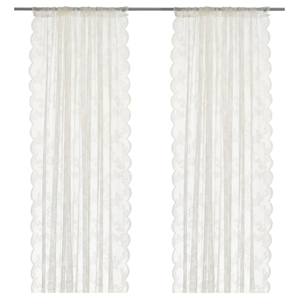 ALVINE SPETS sheer white curtains with lace design and curved edges.