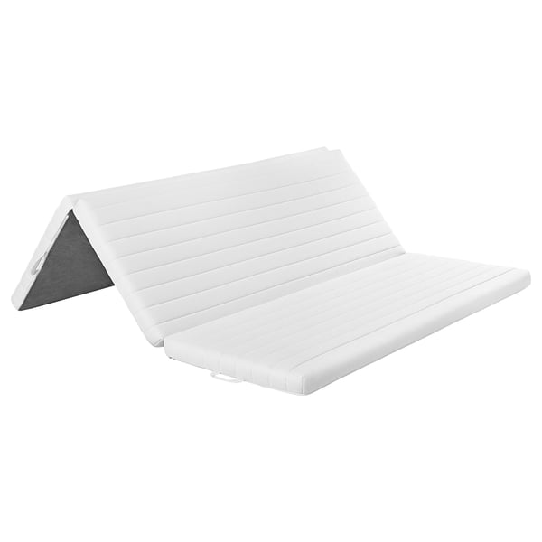 White ÅNNFJÄLLET mattress, rectangular, folded, with fabric cover and foam layer.