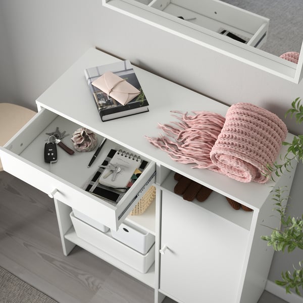 White dresser with drawers and shelves. Stores various items like keys, notebook, and blanket. Supports wall attachment for safety.