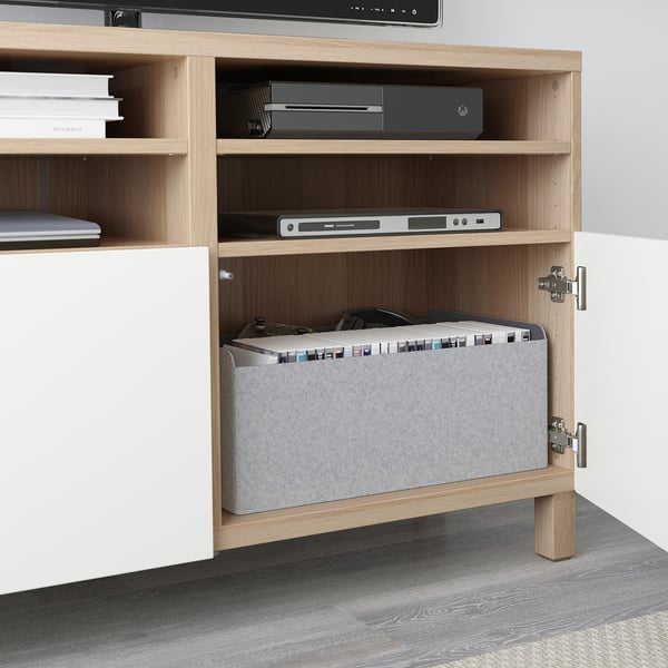Light wood tv stand with hidden cable storage, soft-close doors, and adjustable shelves.