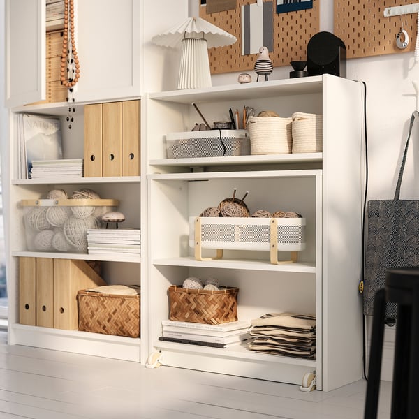 White BILLY bookcase with shelves for storage and display, featuring a foldable table, perfect for work, books, and decor.