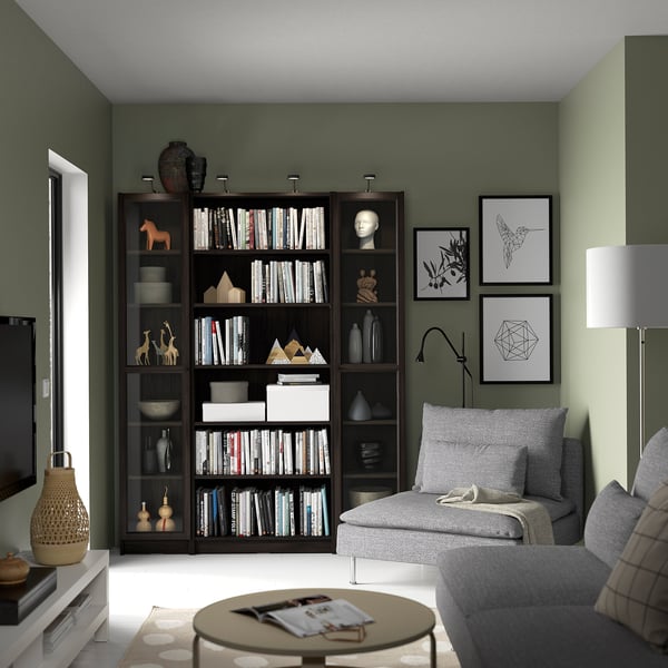 Living room with BILLY bookshelf, grey couch, lamps, and modern decor.