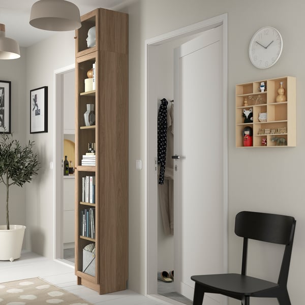 Living room with BILLY bookcase, clock, chair & decor.
