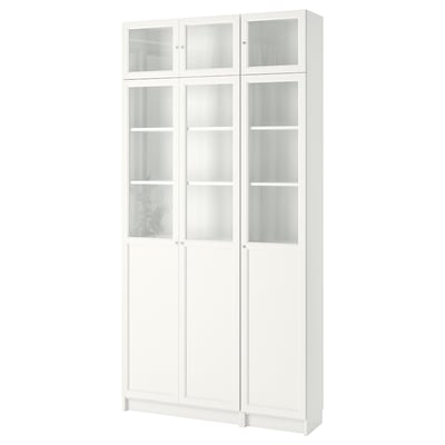 A white BILLY bookcase with glass doors. Its tall and rectangular, featuring adjustable shelves.