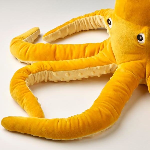 Plush octopus toy, bright yellow, soft, detailed tentacles, friendly face, quality craftsmanship.