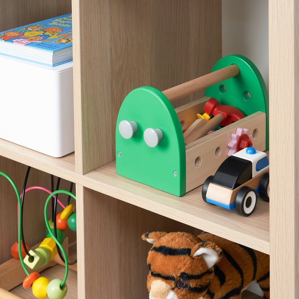 A colourful childrens toolbox filled with toy tools like a hammer and screwdriver, ideal for developing motor skills and creativity.