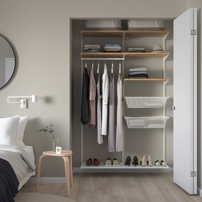 BOAXEL storage system in closet, white, with shelves, rails, and baskets for efficient bedroom storage.