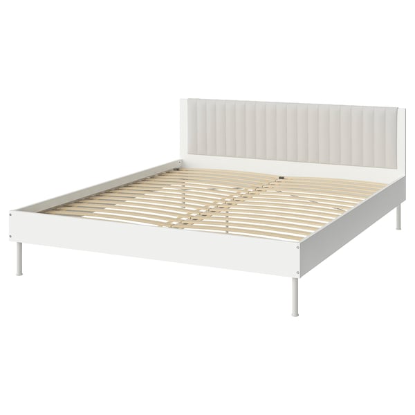 A white BRUKSVARA bed frame with a padded headboard, wooden slats, and metal legs.