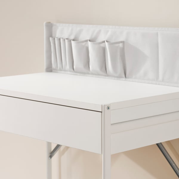 White dressing table with drawer, featuring fabric pockets for organising items. Clean and modern design.