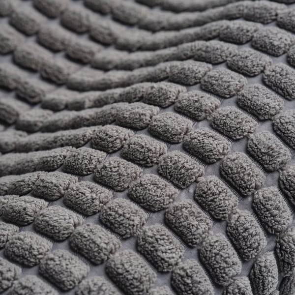 Close-up of textured, soft, grey kitchen mat with anti-slip design.