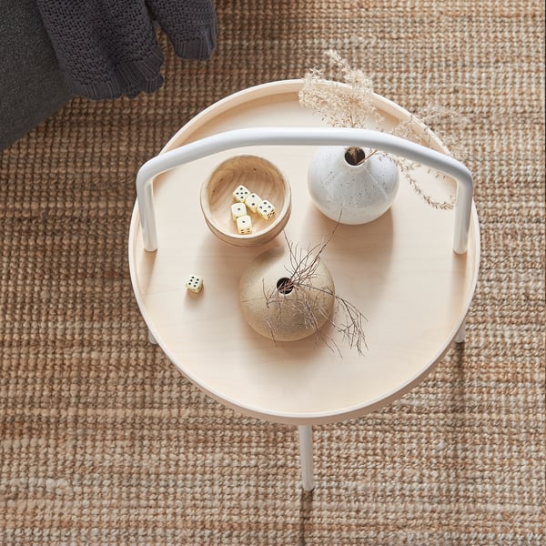 Birdseye view: light wooden side table with handles. Includes dice, vases, and dried plants. Neutral, minimalist design.