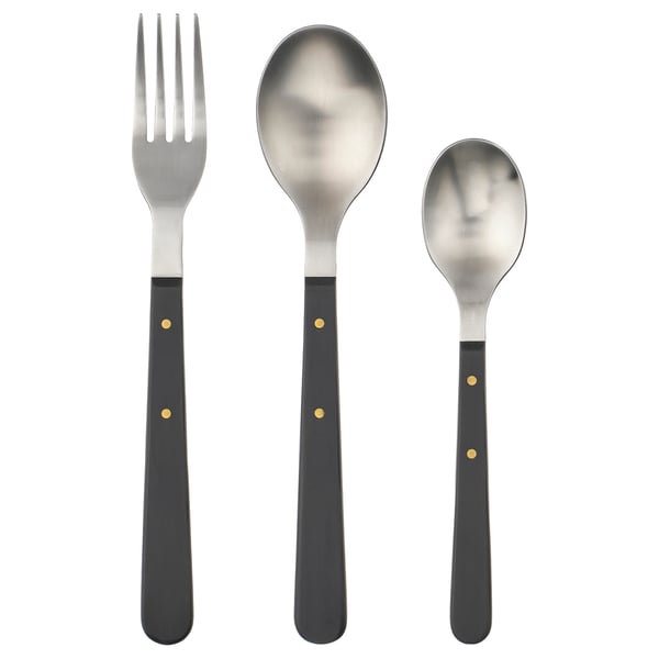 Elegant DOFTSKÖLD cutlery set in black, featuring gold details. Includes fork, large spoon, and small spoon, all in sleek, stainless steel design.