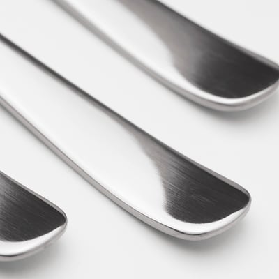 Three polished, sleek stainless steel spoons arranged together, reflecting light, showing durability and quality.