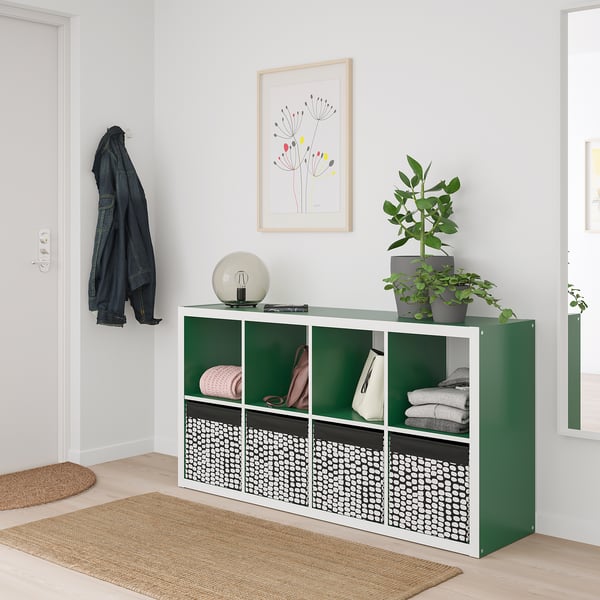 Entryway featuring the DRÖNA storage box in green fabric, neatly organising items inside a kallax unit, with coats and a plant adding a touch of life.