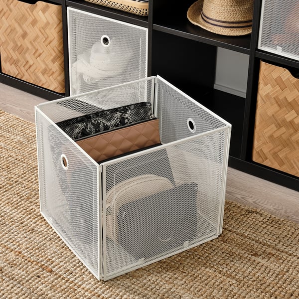 White metal storage box with mesh net, open and showing interior. Part of DRÖNJÖNS series, fits kallax shelving, easy to pull out.