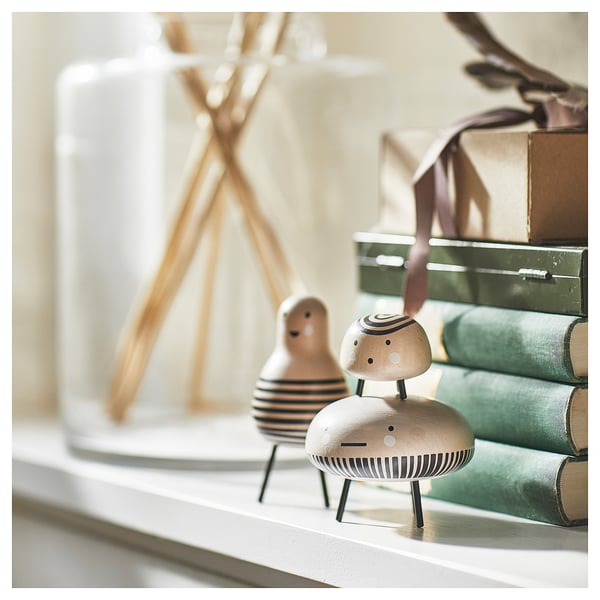 Wooden figures with interchangeable legs on shelf.