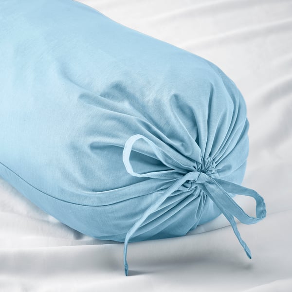 Light blue bolster pillow, tied with a bow, resting on a white surface. Soft, durable cotton material.