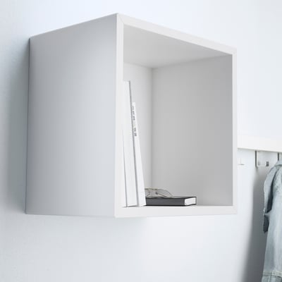 A minimalist floating shelf, part of the EKET series, displaying a few items.
