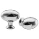 Two shiny chrome cabinet knobs, one round with flared edges and the other more elongated, showcasing a traditional design.