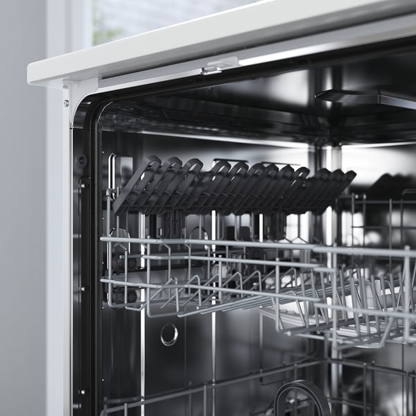 Black-and-white an open dishwasher with its racks empty, showing top and bottom compartments with steam prevention adhesive.