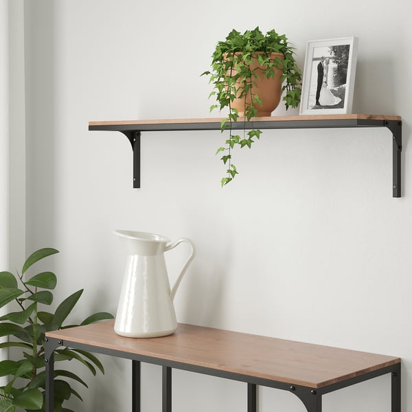 Wall shelf FJÄLLBO with plant and frame. Wooden, black brackets.