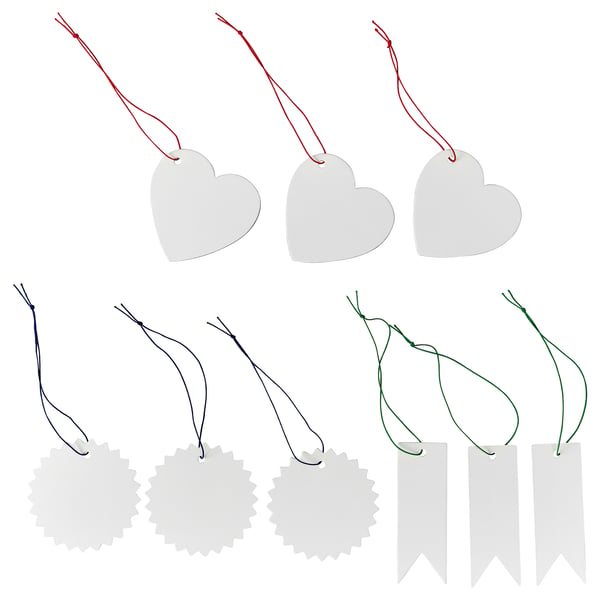 Image FÖNSTERFIKUS labels in heart, flower, and ribbon shapes. Labels are white, made of paperboard, attached with colourful elastic strings.