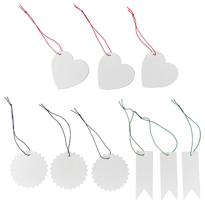 Image FÖNSTERFIKUS labels in heart, flower, and ribbon shapes. Labels are white, made of paperboard, attached with colourful elastic strings.