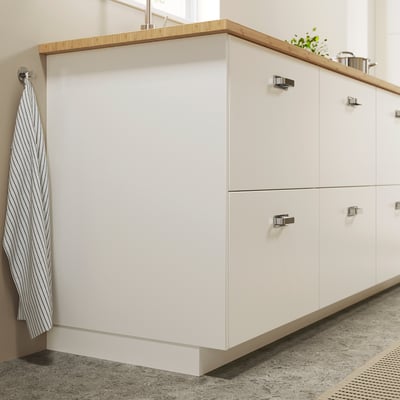 Modern white bathroom vanity with striped towel. Simple design, clean lines.