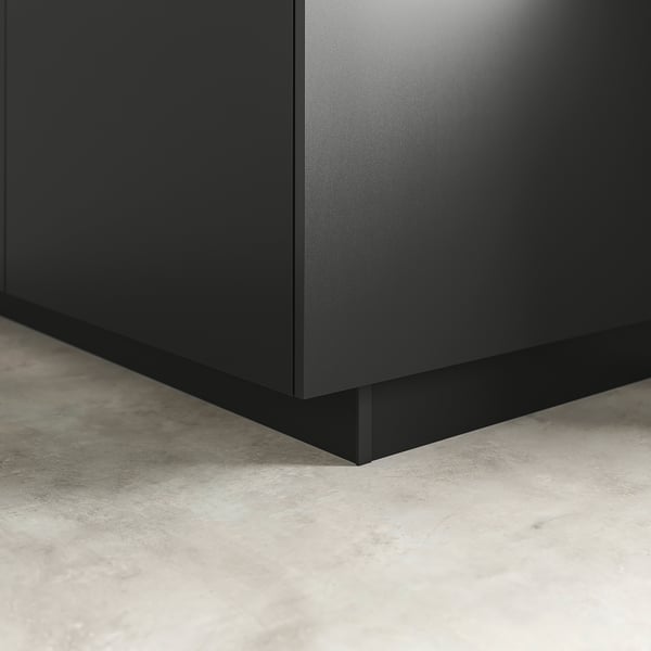 Black kitchen plinth, blending cabinets with floor, sleek & modern.