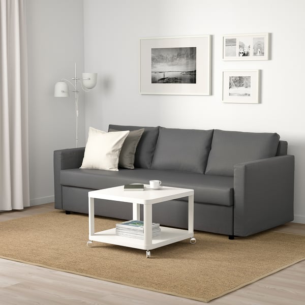 Modern minimalist living room with grey FRIHETEN sofa, white coffee table, and coordinating decor.