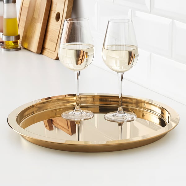 Two wine glasses on a shiny gold tray. The tray has a protective edge to prevent items from sliding off.