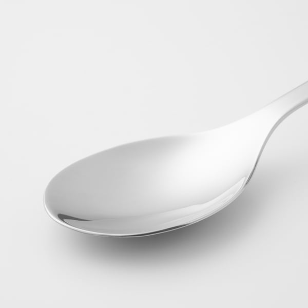 Sleek, polished stainless steel spoon; reflective surface, smooth edges, and elegant curve.