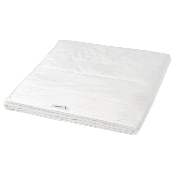 A white GRUSSTARR duvet with printed dots, made of lyocell and cotton, filled with polyester and viscose, neatly folded.